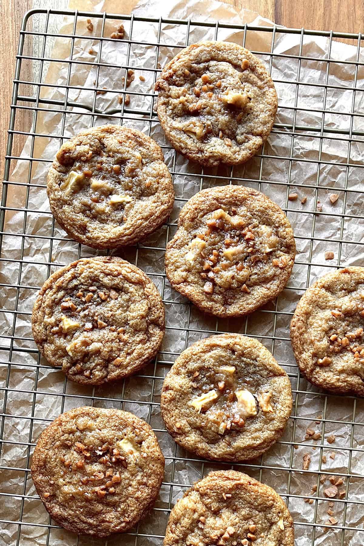 Caramel apple cookies on a cooling wire rack.