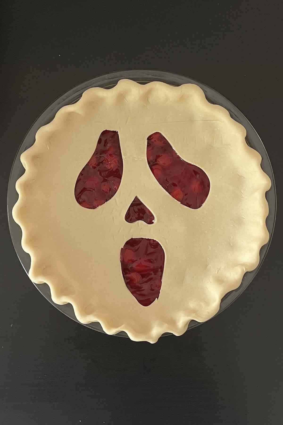 Carved halloween pie sheet transferred on top of the pie filling.