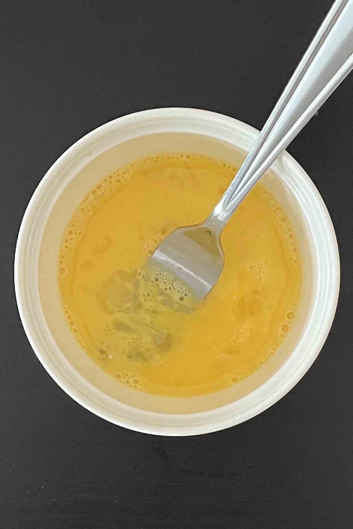 Bowl with egg wash in it.