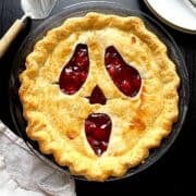 Spooky halloween pie in a glass pie dish.