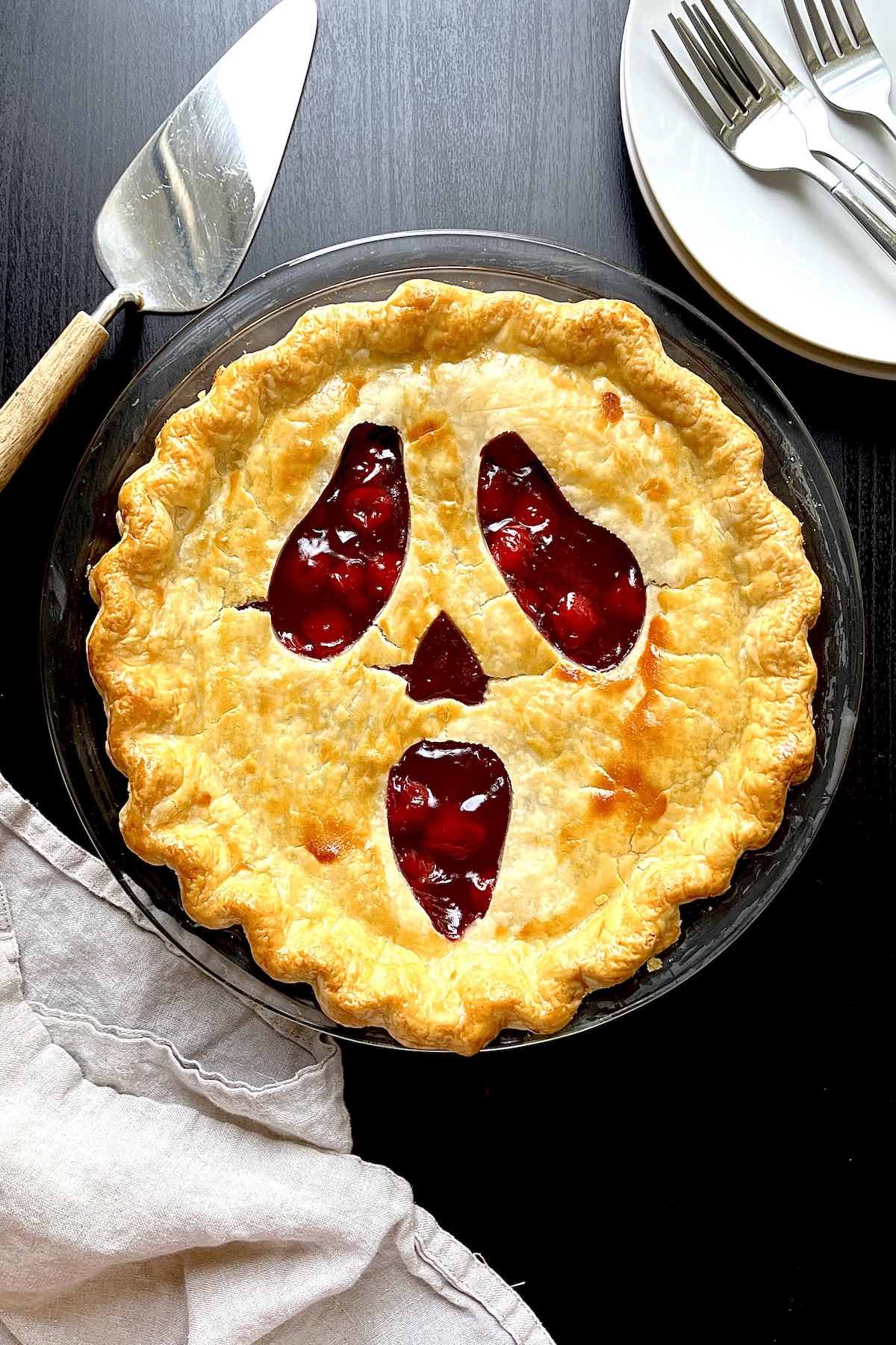 Spooky halloween pie in a glass pie dish.