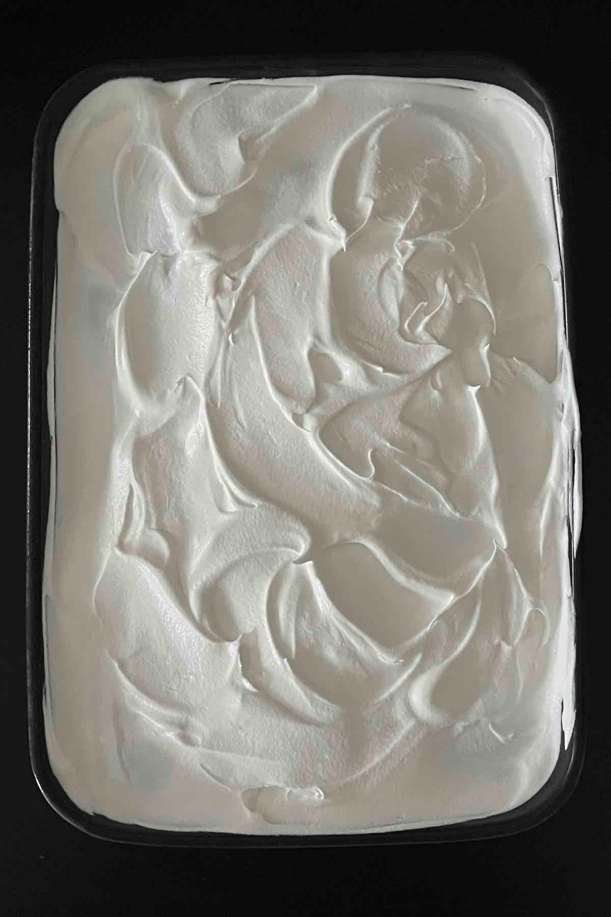 Cool Whip spread over the cake.